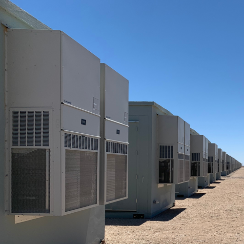 An electrical utility building with a Bard wall-mount air conditioner used to cool the gray space supporting a data center.