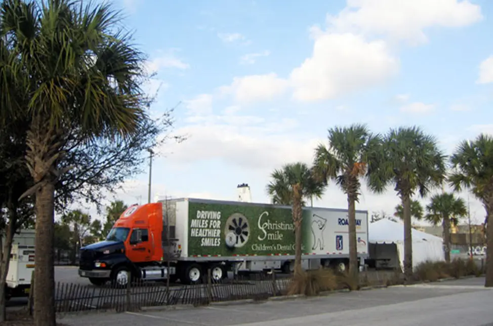 semi truck with Bard unit next to palm trees