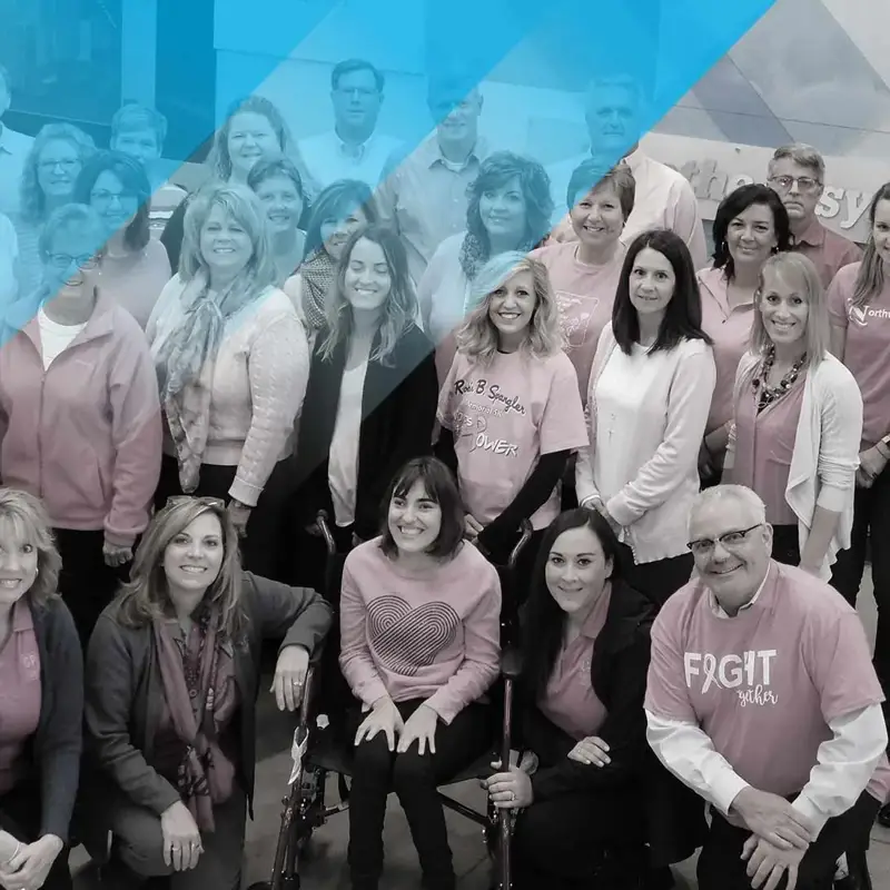 group of people wearing pink shirts