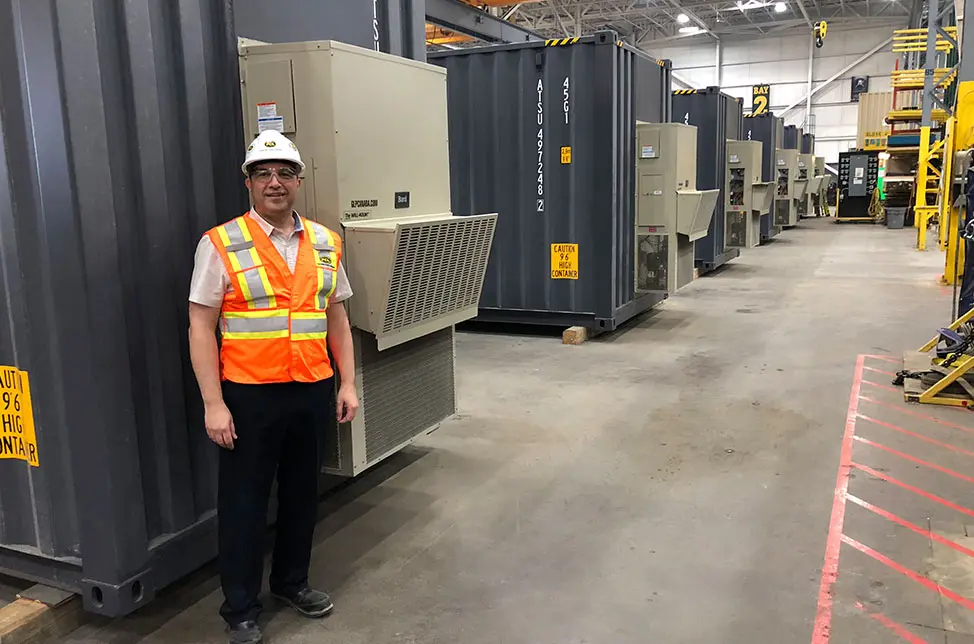 Worker in front of Bard unit in warehouse