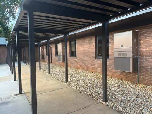 The exterior of a school cooled by Bard exterior wall-mount HVAC units.