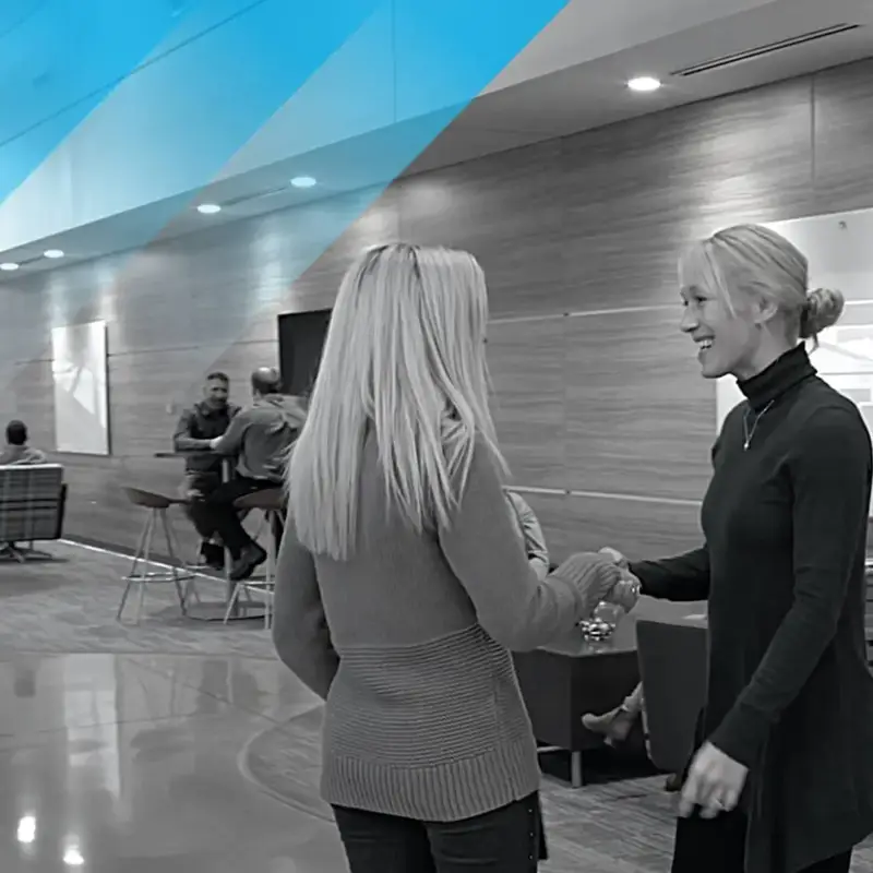 two women shaking hands