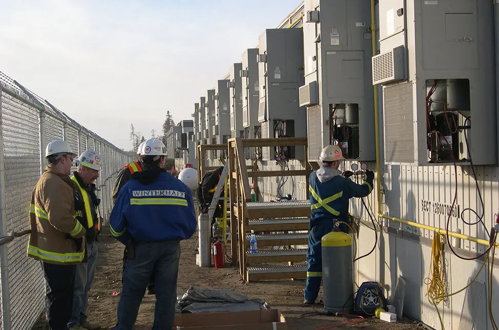 Construction workers in front of exterior Bard units