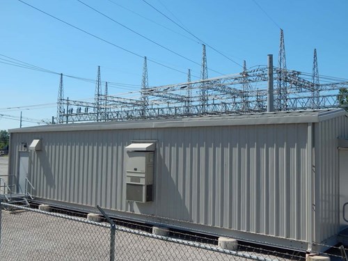 An electrical utility building with a Bard wall-mount air conditioner used to cool the gray space supporting a data center.