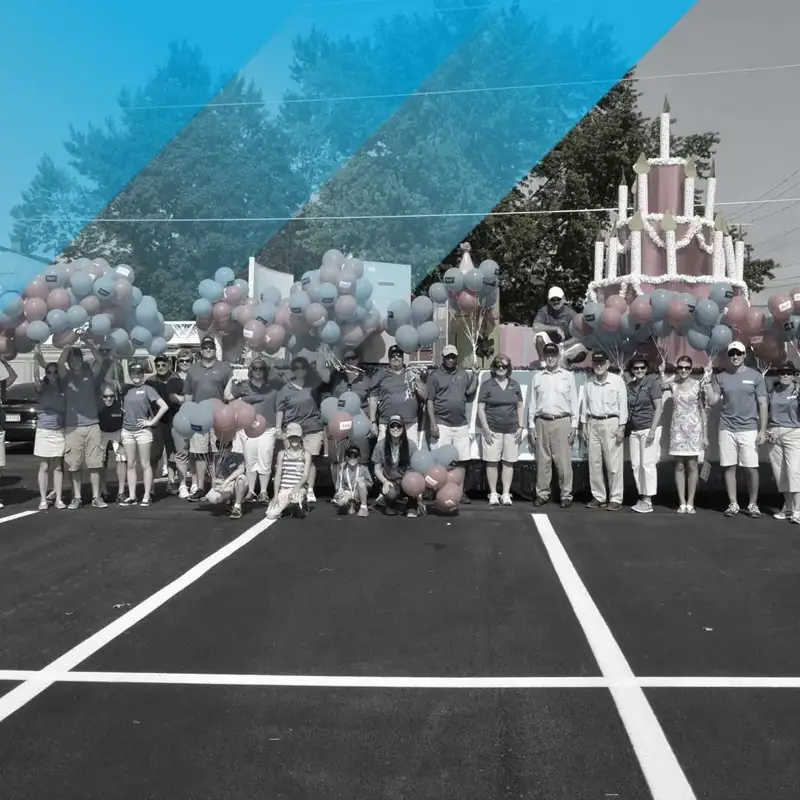 group of people holding balloons