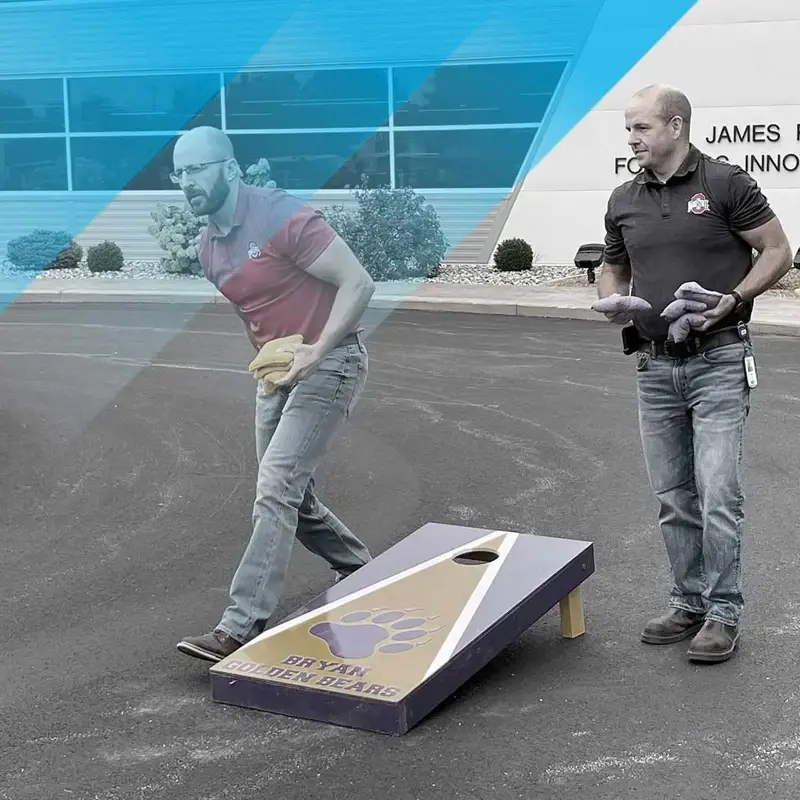two people playing cornhole